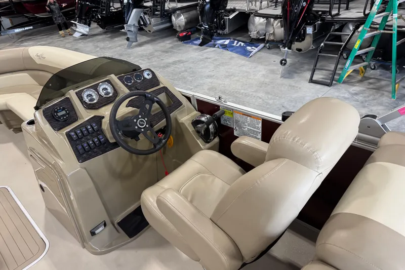 Slide: The Image of 2022 SunChaser Geneva Cruise 24 CRS boat interior with steering console and beige seating. - 11