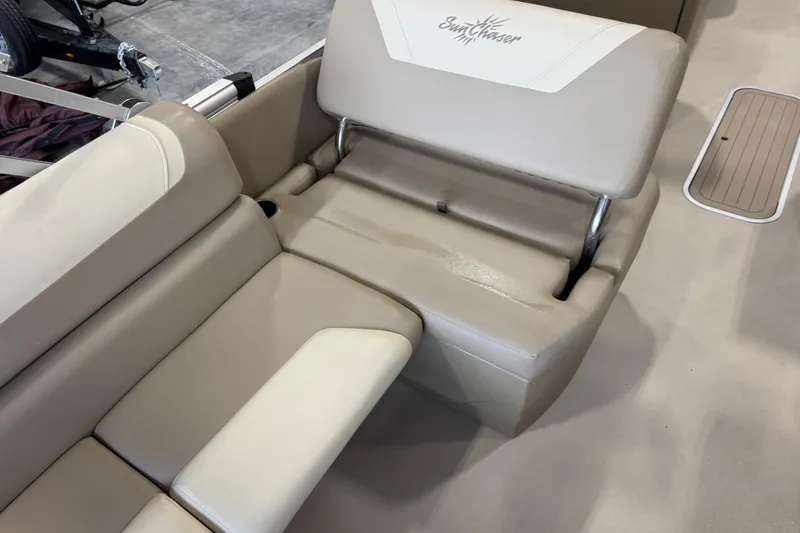 Slide: The Image of 2022 SunChaser Geneva Cruise 24 CRS boat seating with beige upholstery and logo. - 12