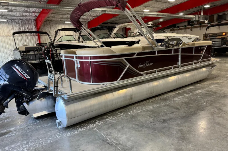 Slide: The Image of 2022 SunChaser Geneva Cruise 24 CRS pontoon boat in a showroom with Mercury outboard motor. - 4