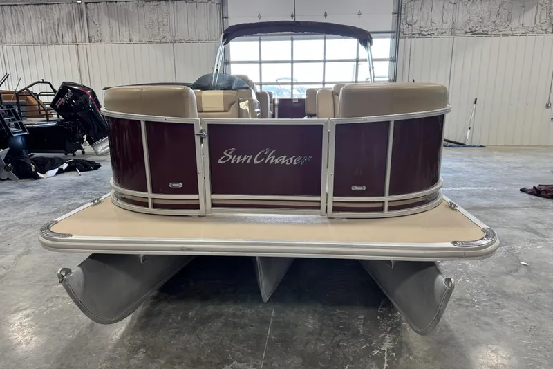 Slide: The Image of 2022 SunChaser Geneva Cruise 24 CRS pontoon boat in a warehouse setting. - 6