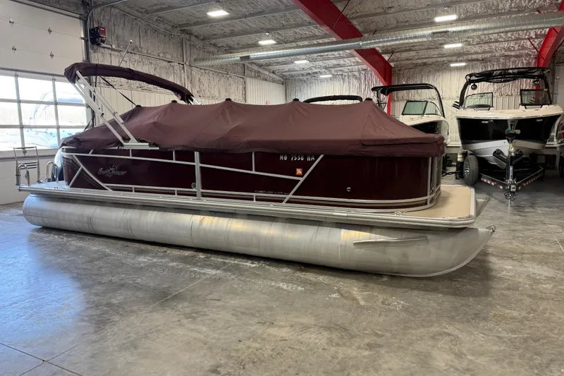 Slide: The Image of 2022 SunChaser Geneva Cruise 24 CRS pontoon boat in a warehouse. - 8