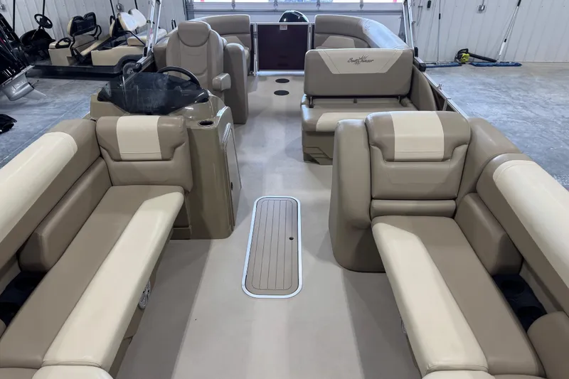 Slide: The Image of 2022 SunChaser Geneva Cruise 24 CRS interior with beige seating and steering console. - 9