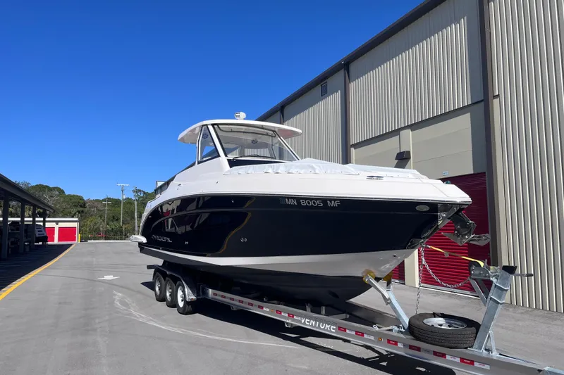Slide: The Image of 2019 Regal 33 SAV boat on trailer near storage facility. - 1