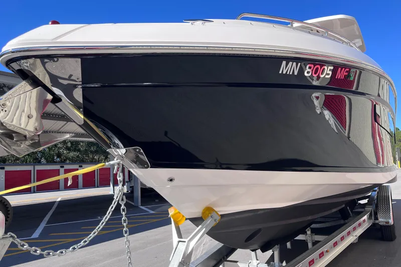 Slide: The Image of 2019 Regal 33 SAV boat on trailer, sleek design, black and white exterior. - 10