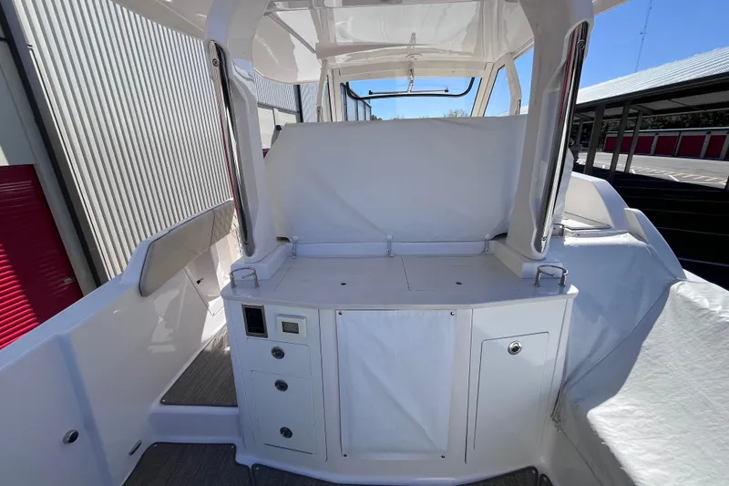 Slide: The Image of 2019 Regal 33 SAV boat interior with covered seating and storage compartments. - 13