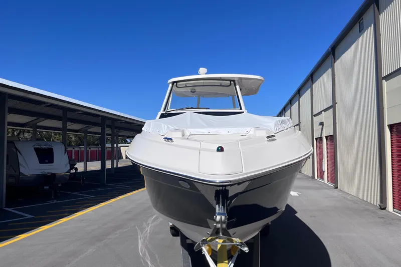 Slide: The Image of 2019 Regal 33 SAV boat parked in storage facility under clear blue sky. - 2