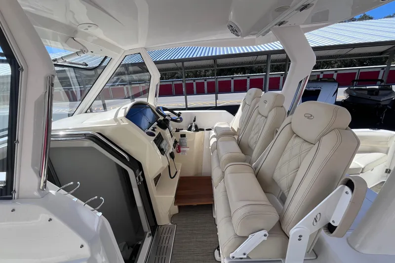 Slide: The Image of 2019 Regal 33 SAV boat interior with luxurious seating and modern dashboard. - 23