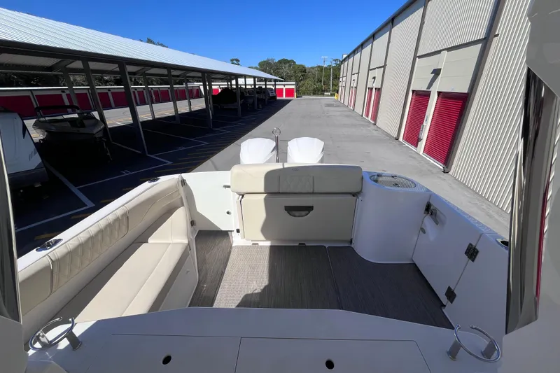 Slide: The Image of 2019 Regal 33 SAV boat interior with seating, docked in storage facility. - 25