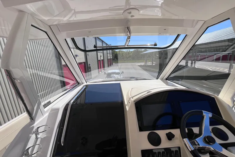 Slide: The Image of 2019 Regal 33 SAV boat cockpit with modern controls and panoramic view. - 27