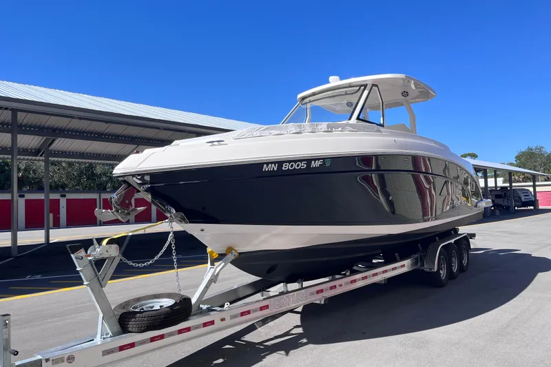 Slide: The Image of 2019 Regal 33 SAV boat on trailer under clear blue sky. - 3