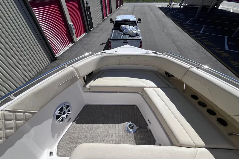 Slide: The Image of 2019 Regal 33 SAV boat interior with beige seating, parked near storage units. - 32