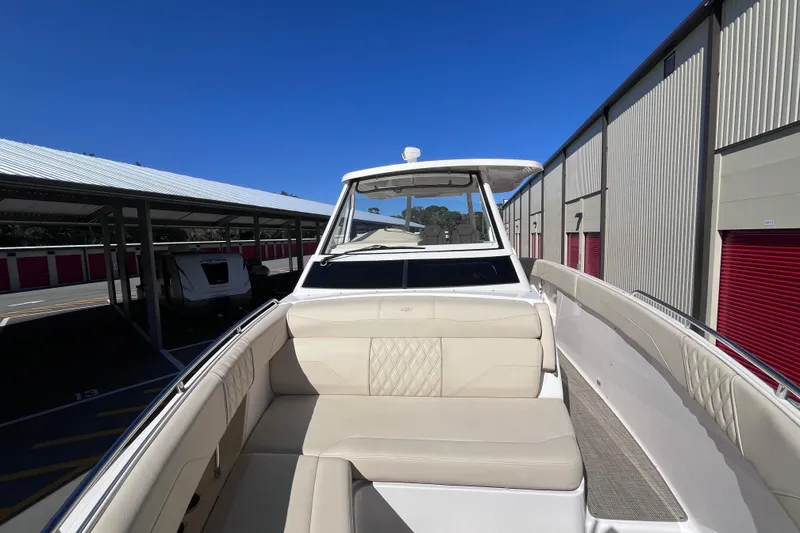 Slide: The Image of 2019 Regal 33 SAV boat with beige seating, parked in storage facility. - 34