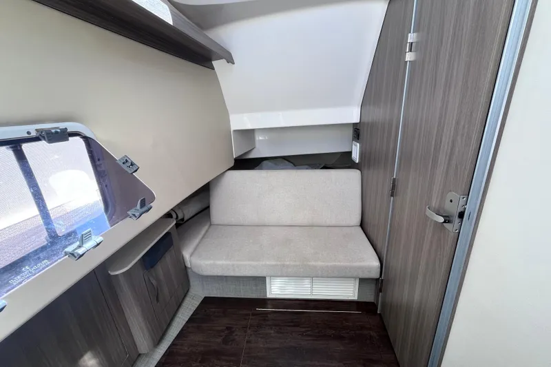 Slide: The Image of 2019 Regal 33 SAV cabin interior with seating and window view. - 36