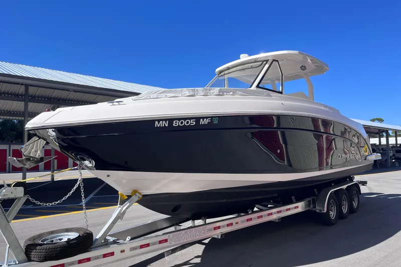 Slide: The Image of 2019 Regal 33 SAV boat on trailer under clear blue sky. - 4