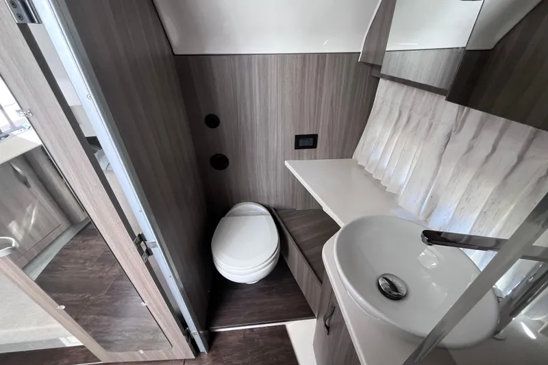 Slide: The Image of 2019 Regal 33 SAV boat bathroom with modern sink and toilet. - 41