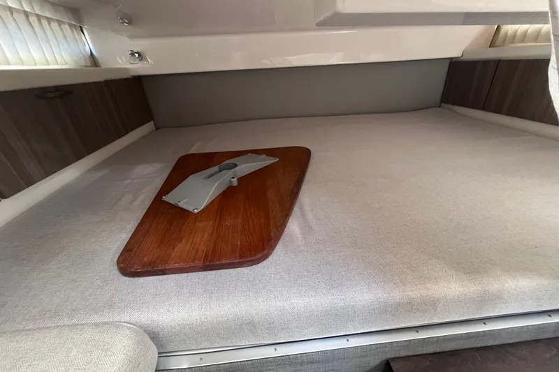 Slide: The Image of Interior cabin of 2019 Regal 33 SAV boat with wooden table and cushioned seating. - 44