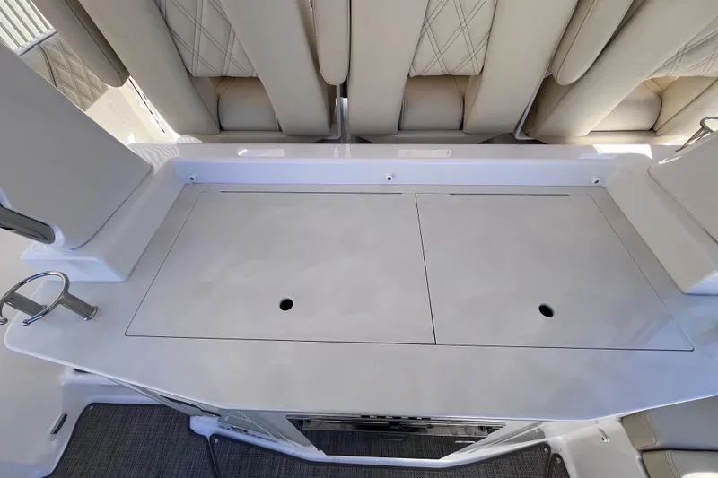 Slide: The Image of 2019 Regal 33 SAV boat interior with cushioned seating and storage compartments. - 47