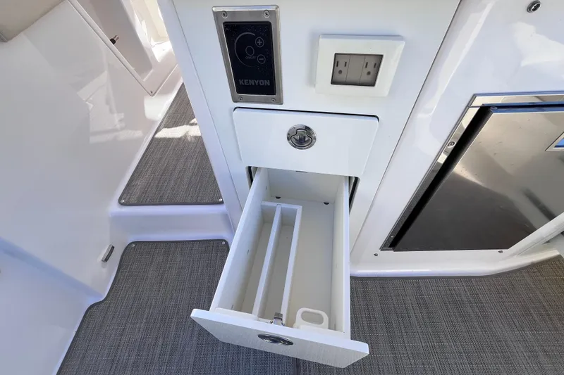 Slide: The Image of 2019 Regal 33 SAV boat interior with open drawer and electrical outlet. - 52