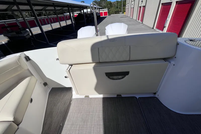 Slide: The Image of 2019 Regal 33 SAV boat interior with beige seating and storage compartment. - 63