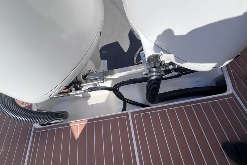 Slide: The Image of 2019 Regal 33 SAV boat engine compartment with visible hoses and connections. - 67