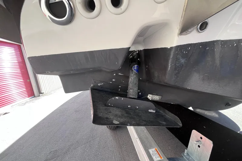 Slide: The Image of 2019 Regal 33 SAV boat hull and trim tab detail in storage facility. - 74