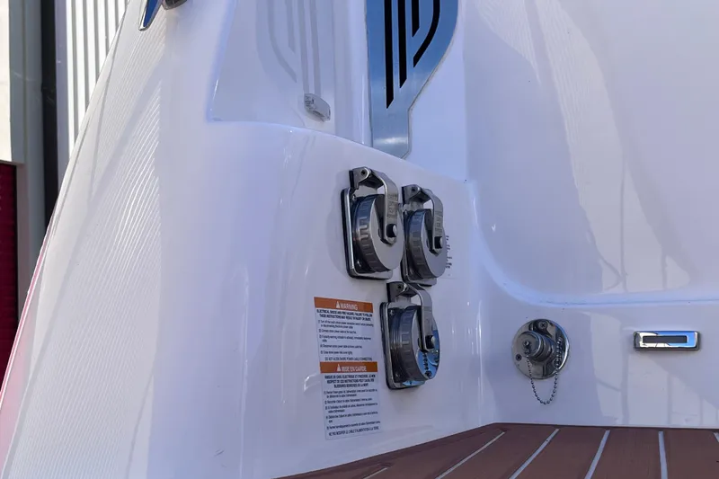 Slide: The Image of 2019 Regal 33 SAV boat stern with fuel caps and warning labels. - 79