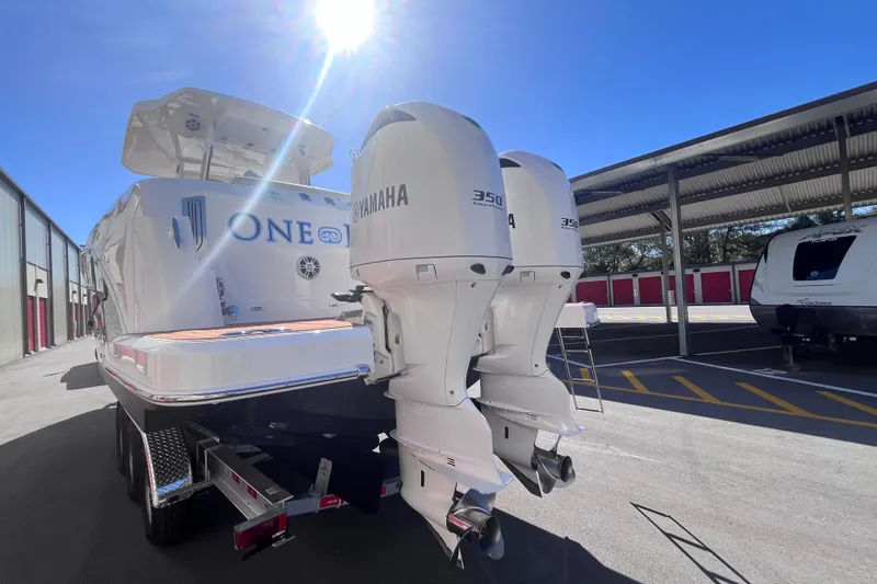 Slide: The Image of 2019 Regal 33 SAV boat with twin Yamaha 350 engines in a sunny storage area. - 80