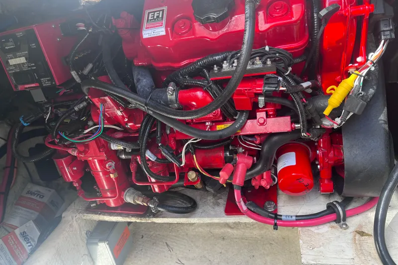 Slide: The Image of 2019 Regal 33 SAV engine compartment with red EFI engine components and wiring. - 82