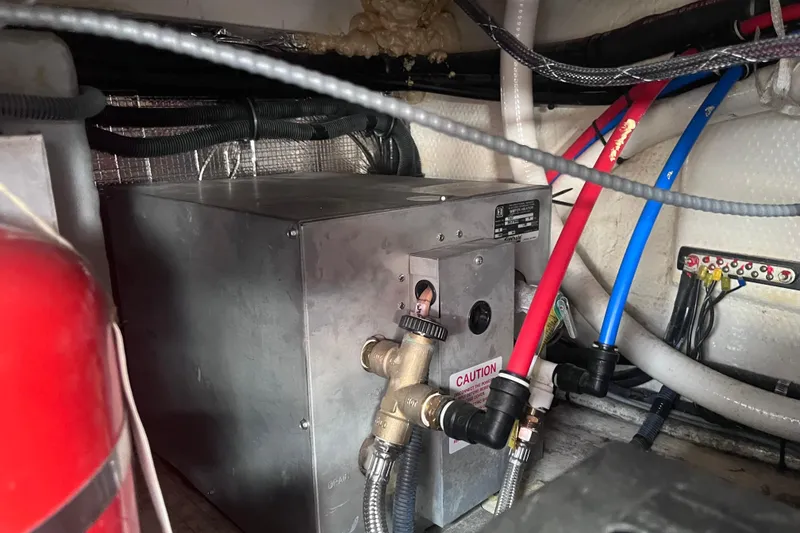 Slide: The Image of 2019 Regal 33 SAV engine compartment with wiring and plumbing connections. - 86