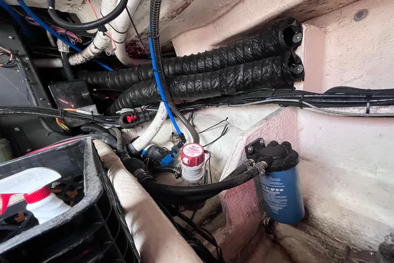 Slide: The Image of Engine compartment of 2019 Regal 33 SAV boat with hoses and filter system. - 90