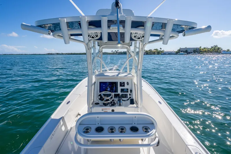 Slide: The Image of 2017 SeaVee 270Z boat on sparkling water, featuring a modern helm and T-top. - 10