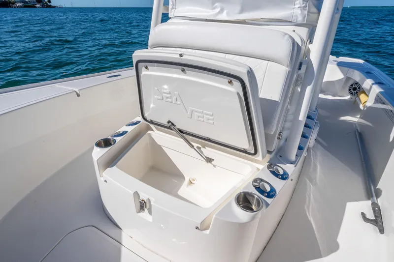 Slide: The Image of 2017 SeaVee 270Z boat interior with open storage compartment on a sunny day. - 16