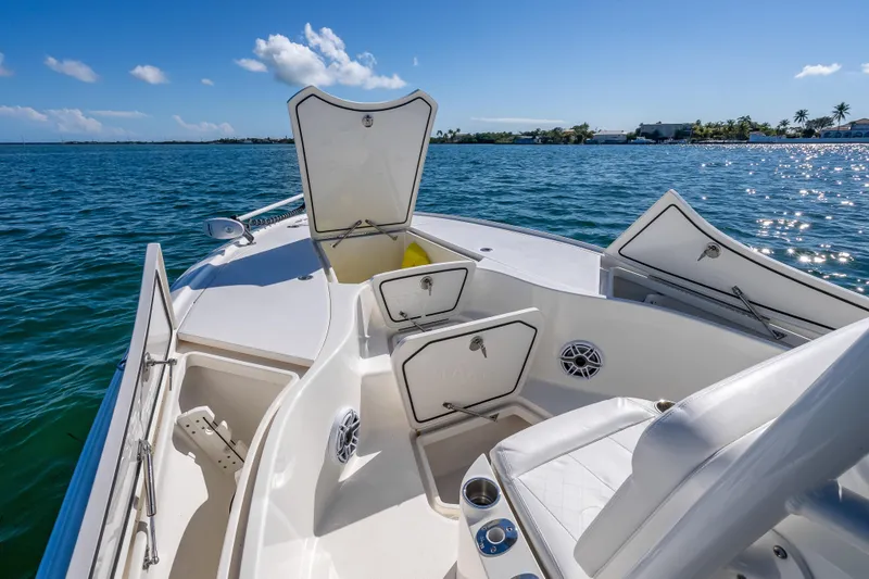 Slide: The Image of 2017 SeaVee 270Z boat interior with open storage compartments on a sunny day. - 19