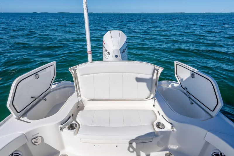 Slide: The Image of 2017 SeaVee 270Z boat with open storage compartments on a calm ocean. - 20