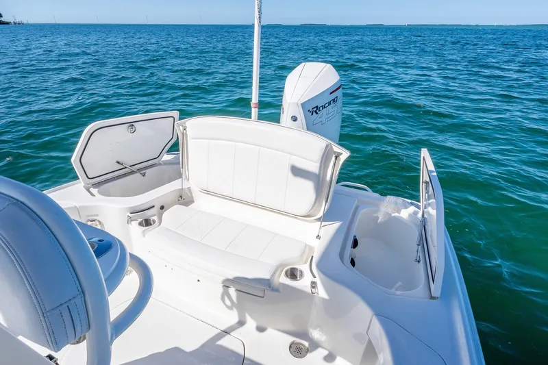 Slide: The Image of 2017 SeaVee 270Z boat interior with seating and storage, overlooking blue ocean waters. - 22