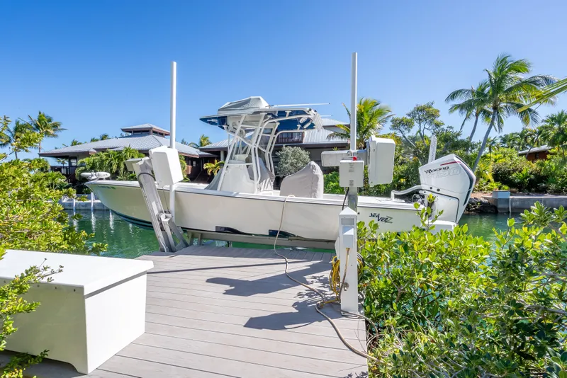 Slide: The Image of 2017 SeaVee 270Z boat docked in tropical setting with lush greenery and clear blue sky. - 3