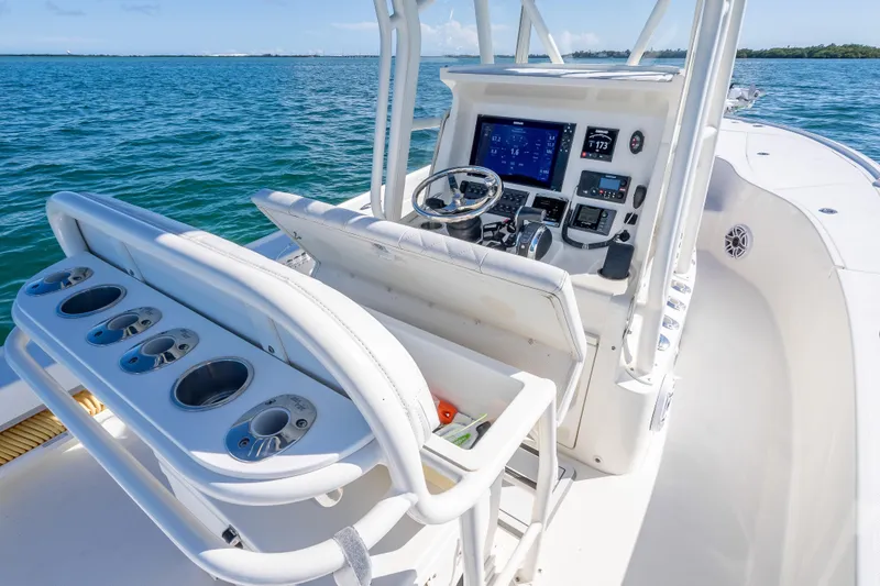 Slide: The Image of 2017 SeaVee 270Z boat cockpit with modern controls and rod holders on open water. - 6