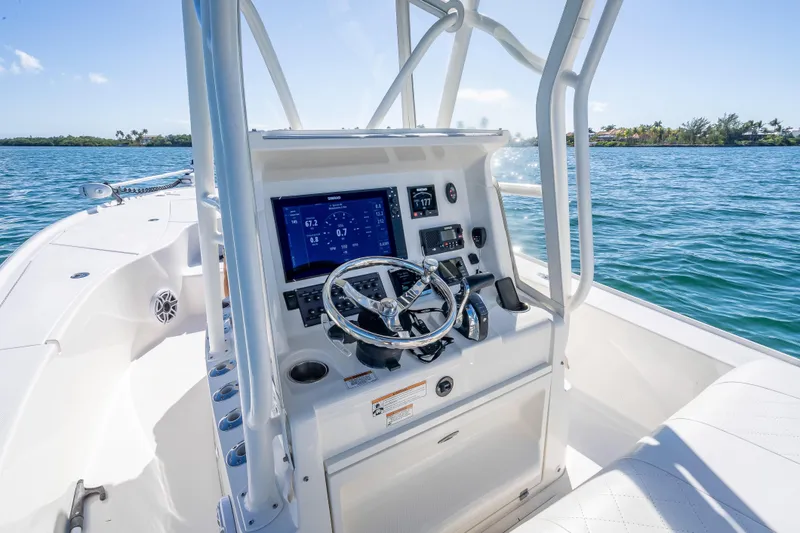 Slide: The Image of 2017 SeaVee 270Z boat console with steering wheel and navigation display on open water. - 8