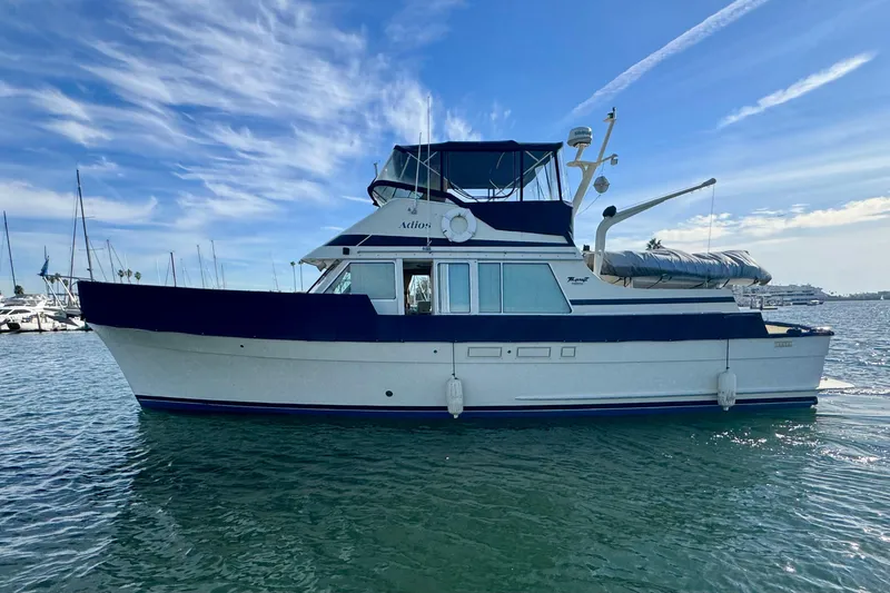The Image of 1985 Tollycraft 48 Cockpit Motor Yacht on calm water under blue sky. - 0