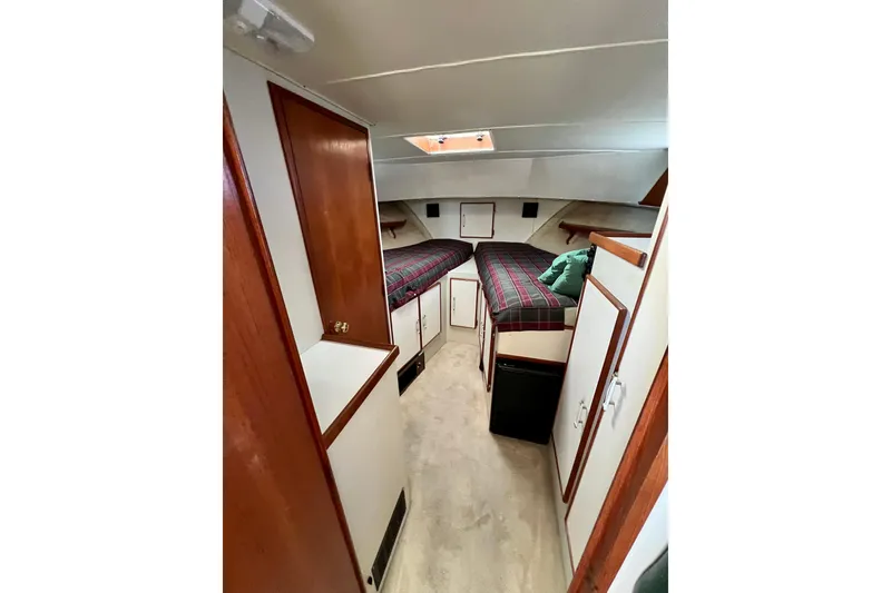 Slide: The Image of 1985 Tollycraft 48 Cockpit Motor Yacht interior with wood paneling and green seating. - 103