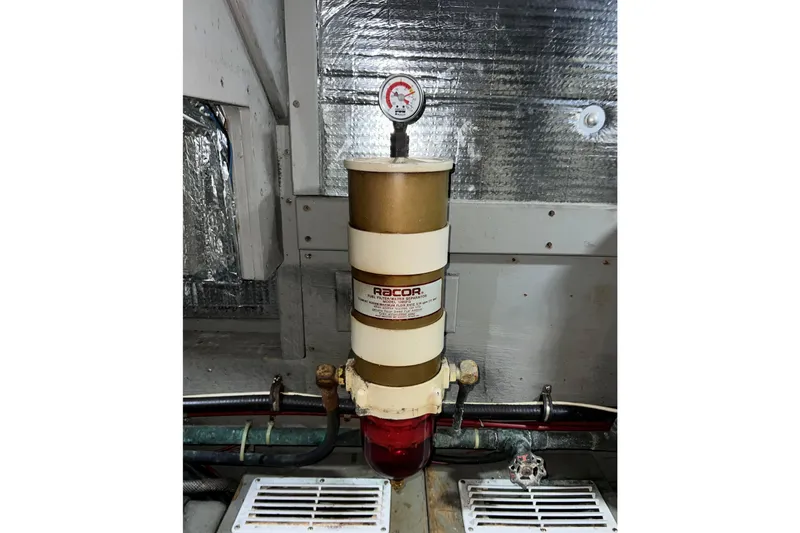 Slide: The Image of Engine room of 1985 Tollycraft 48 Cockpit Motor Yacht, featuring mechanical components. - 125