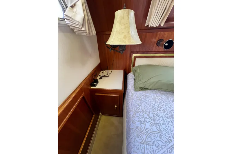 Slide: The Image of Interior of 1985 Tollycraft 48 Cockpit Motor Yacht with wood paneling and cozy bedding. - 137