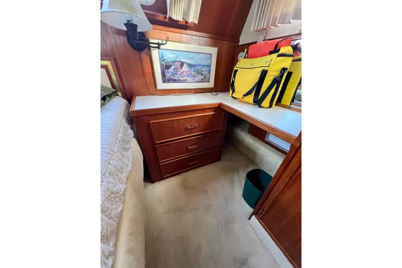 Slide: The Image of Cozy bedroom interior of 1985 Tollycraft 48 Cockpit Motor Yacht with elegant wood paneling. - 138
