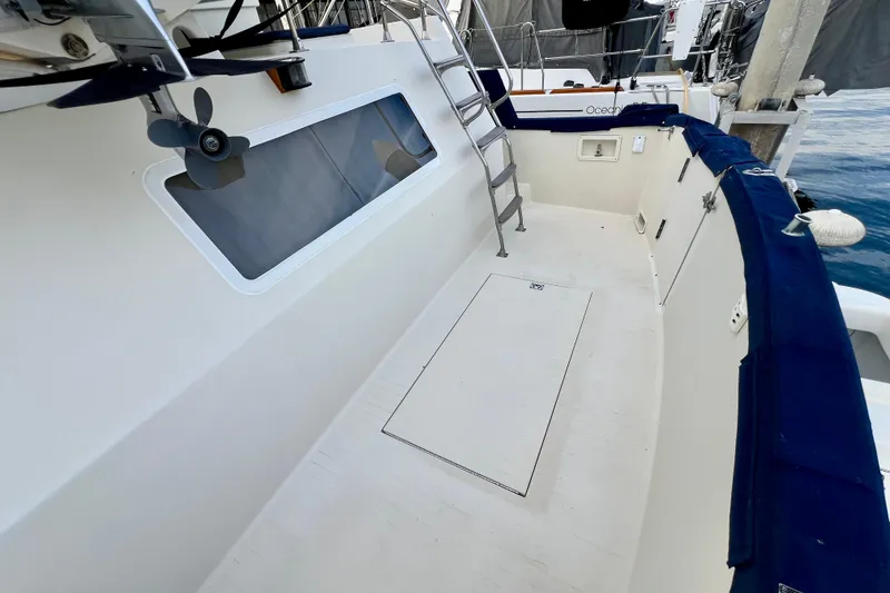 Slide: The Image of 1985 Tollycraft 48 Cockpit Motor Yacht deck with ladder and window view. - 25