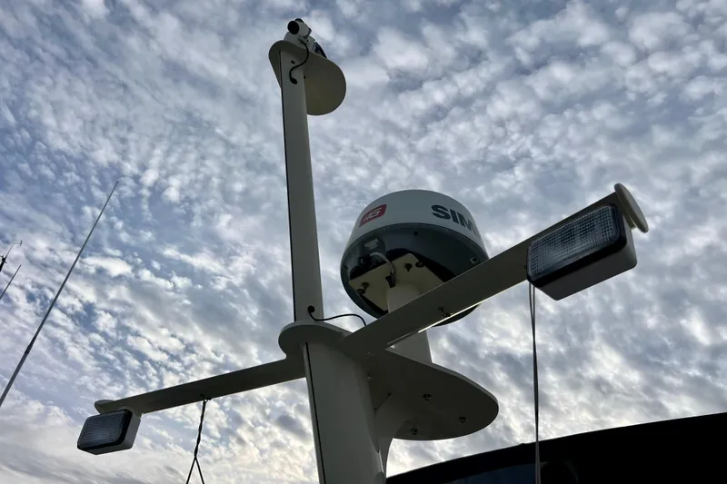 Slide: The Image of 1985 Tollycraft 48 Cockpit Motor Yacht with radar equipment against a cloudy sky. - 38