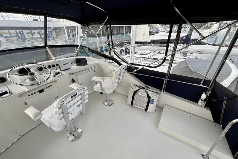 Slide: The Image of 1985 Tollycraft 48 Cockpit Motor Yacht helm with steering wheel and navigation equipment. - 43