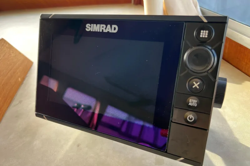 Slide: The Image of Control panel of 1985 Tollycraft 48 Cockpit Motor Yacht with Simrad navigation system. - 69