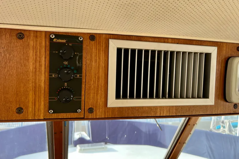 Slide: The Image of Control panel of 1985 Tollycraft 48 Cockpit Motor Yacht with wood finish and audio controls. - 72