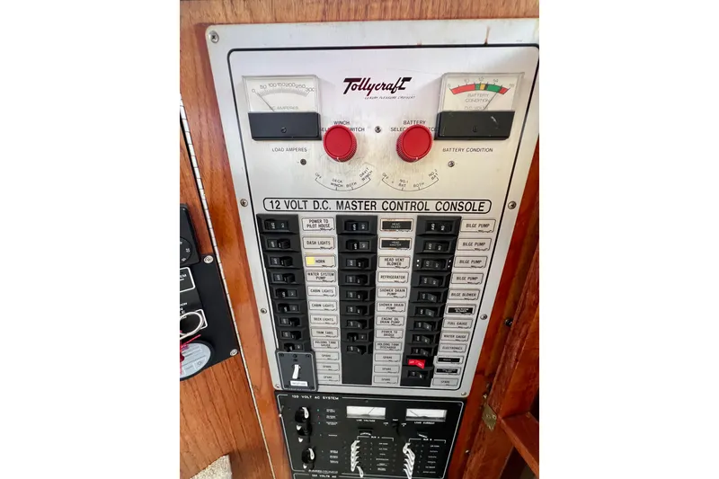 Slide: The Image of 1985 Tollycraft 48 Cockpit Motor Yacht helm with wooden paneling and steering wheel. - 77