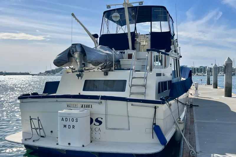 Slide: The Image of 1985 Tollycraft 48 Cockpit Motor Yacht on calm water under blue sky. - 8
